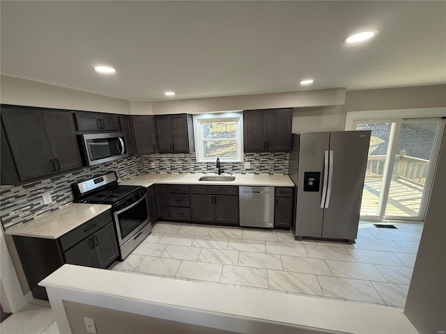 kitchen featuring decorative backsplash, sink, dark brown cabinetry, and stainless steel appliances