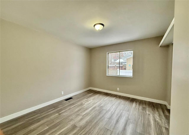 spare room with hardwood / wood-style flooring