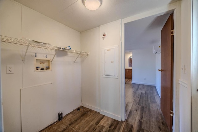 laundry area featuring dark wood-type flooring, washer hookup, and electric panel