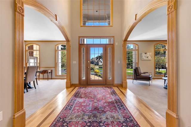 foyer featuring a high ceiling and light hardwood / wood-style flooring