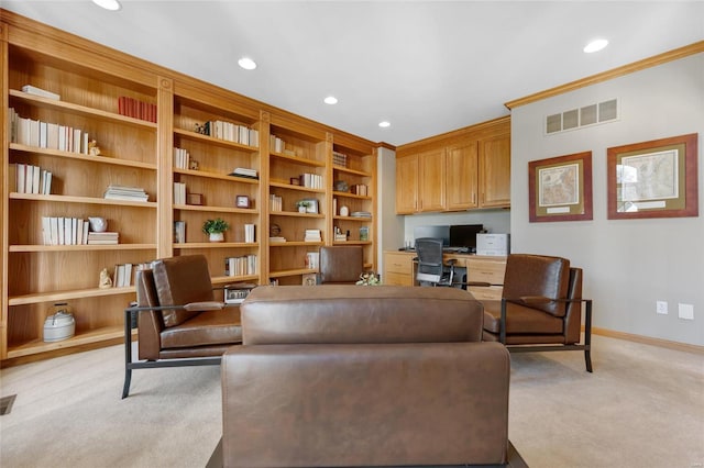 interior space featuring built in desk, light carpet, ornamental molding, and built in features