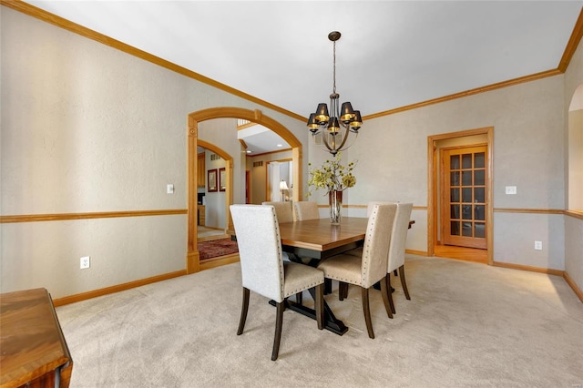 carpeted dining space with an inviting chandelier and ornamental molding