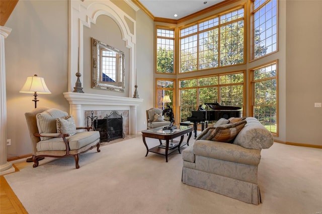 interior space featuring a high end fireplace, a high ceiling, light carpet, and crown molding