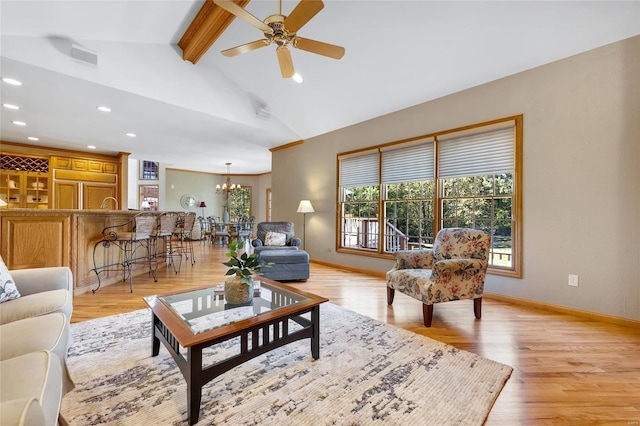 living room featuring light hardwood / wood-style floors, vaulted ceiling with beams, and ceiling fan with notable chandelier