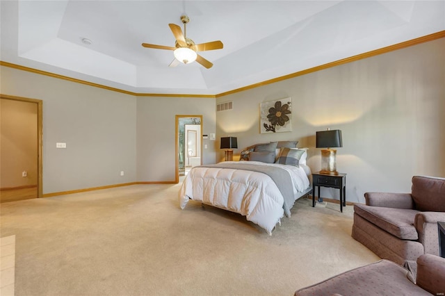 carpeted bedroom featuring ceiling fan, crown molding, and a tray ceiling