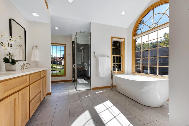 bathroom with independent shower and bath, tile patterned flooring, lofted ceiling, and vanity