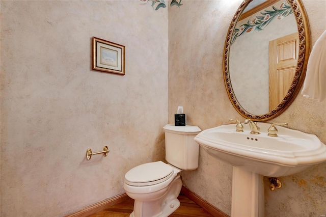 bathroom featuring toilet and hardwood / wood-style floors