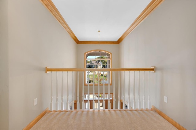 hall with ornamental molding, an inviting chandelier, and carpet floors