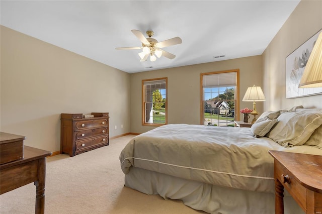 bedroom with light carpet and ceiling fan