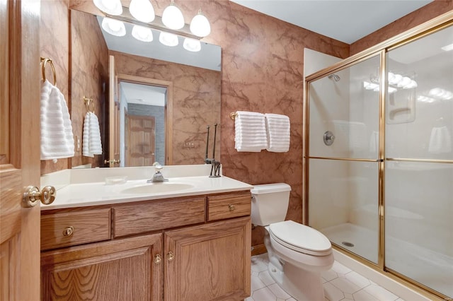 bathroom with toilet, an enclosed shower, tile patterned flooring, and vanity