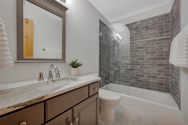 full bathroom featuring toilet, vanity, tiled shower / bath combo, and hardwood / wood-style flooring