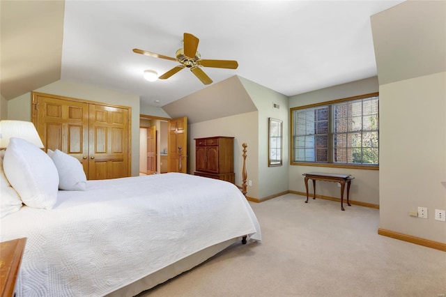 bedroom with ceiling fan, vaulted ceiling, and light colored carpet