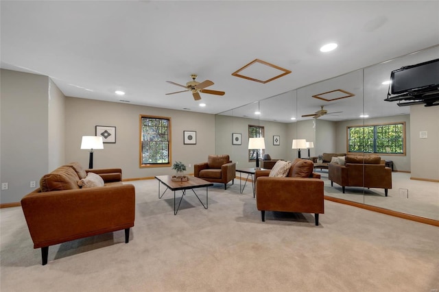 carpeted living room with ceiling fan