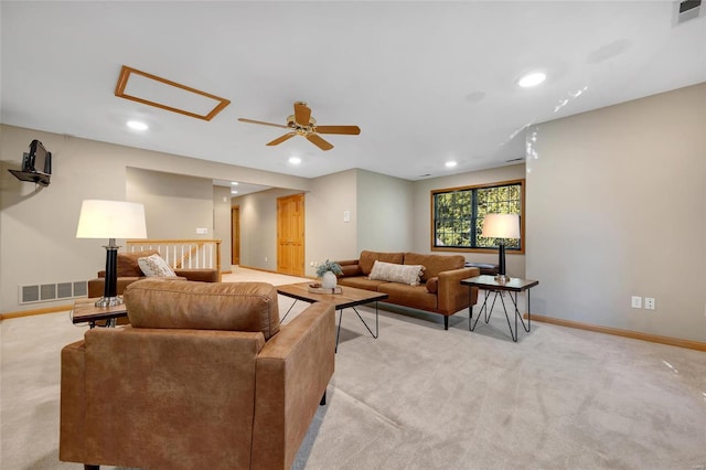 carpeted living room with ceiling fan