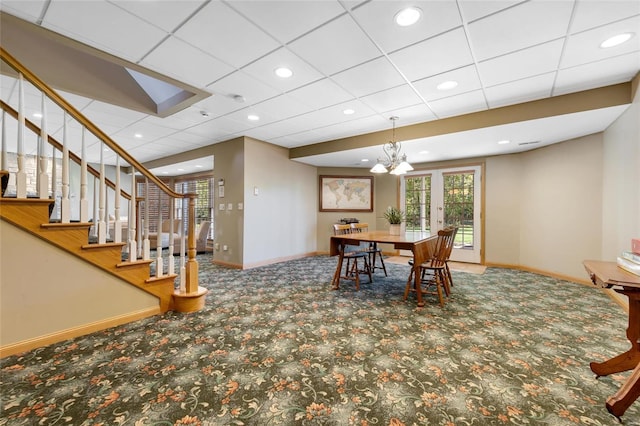 dining area with carpet flooring and a notable chandelier