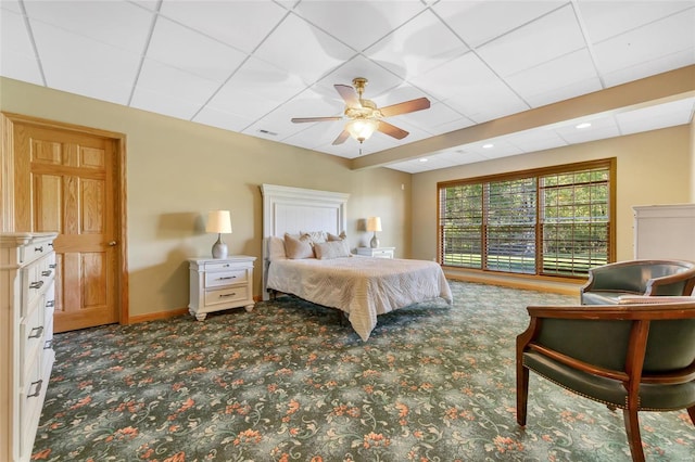 carpeted bedroom featuring a paneled ceiling and ceiling fan