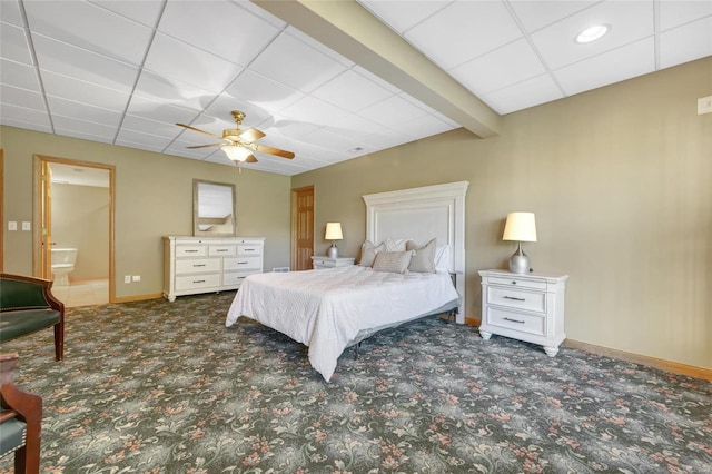 carpeted bedroom featuring a paneled ceiling, connected bathroom, and ceiling fan