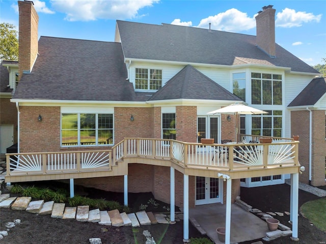 rear view of property featuring a patio and a wooden deck