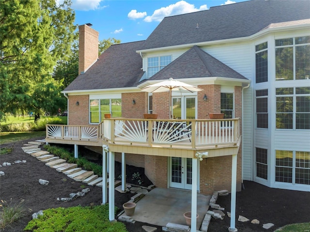 rear view of property featuring a deck and a patio