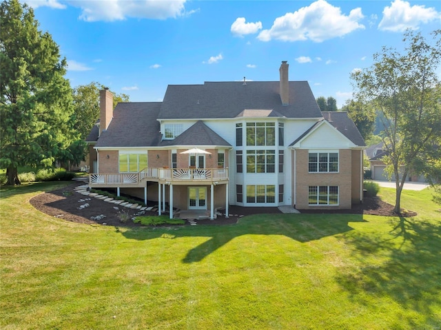 back of house with a yard and a deck