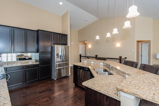 kitchen featuring stainless steel appliances, sink, high vaulted ceiling, dark hardwood / wood-style floors, and hanging light fixtures