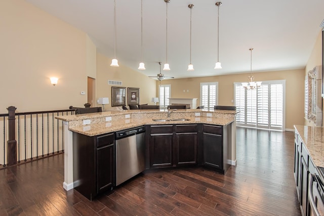 kitchen with hanging light fixtures, a kitchen island with sink, dishwasher, and dark wood-type flooring