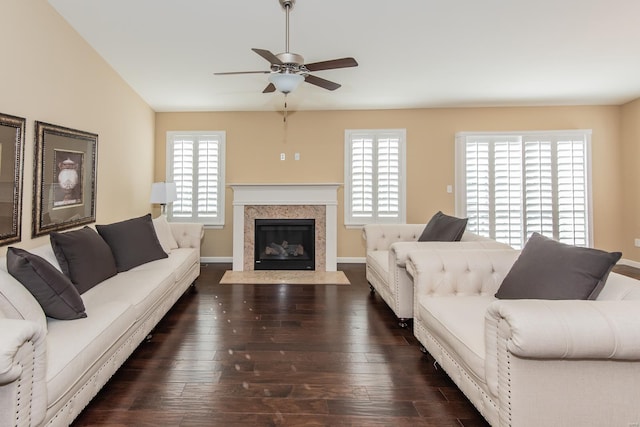 living room with ceiling fan, dark wood-type flooring, and lofted ceiling