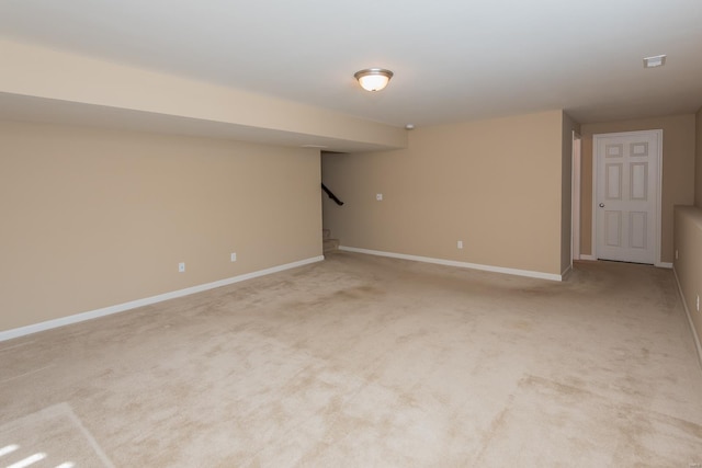 basement featuring light colored carpet