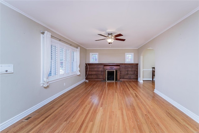 unfurnished living room with crown molding, ceiling fan, and light wood-type flooring