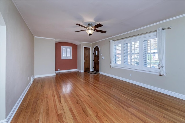 interior space featuring light wood-type flooring, ceiling fan, and crown molding