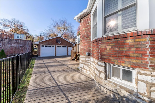 view of home's exterior featuring an outbuilding and a garage