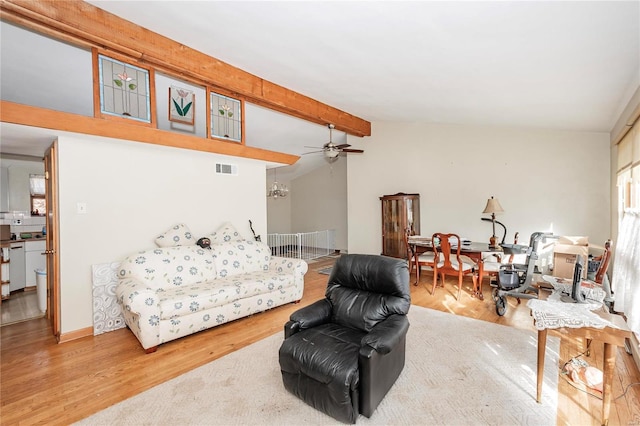 living room featuring wood-type flooring, vaulted ceiling with beams, and ceiling fan