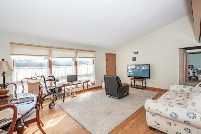 living room with vaulted ceiling and light hardwood / wood-style flooring