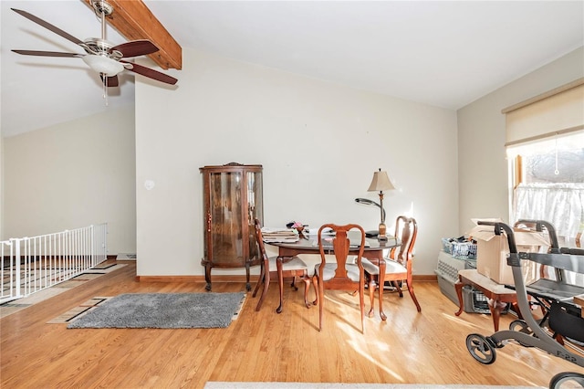 living area featuring lofted ceiling with beams, light hardwood / wood-style flooring, and ceiling fan