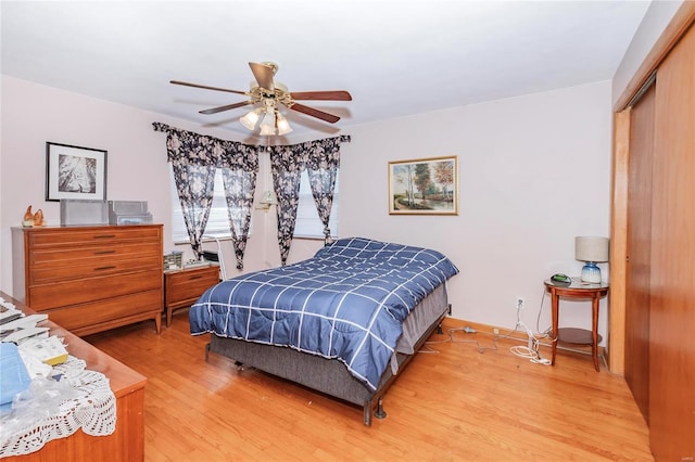 bedroom with wood-type flooring, a closet, and ceiling fan