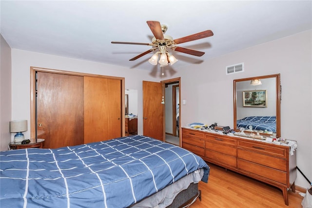 bedroom featuring ceiling fan, a closet, and wood-type flooring