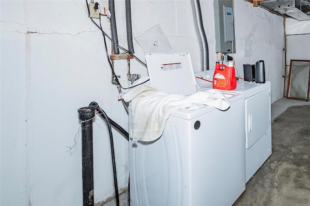 clothes washing area with separate washer and dryer and electric panel