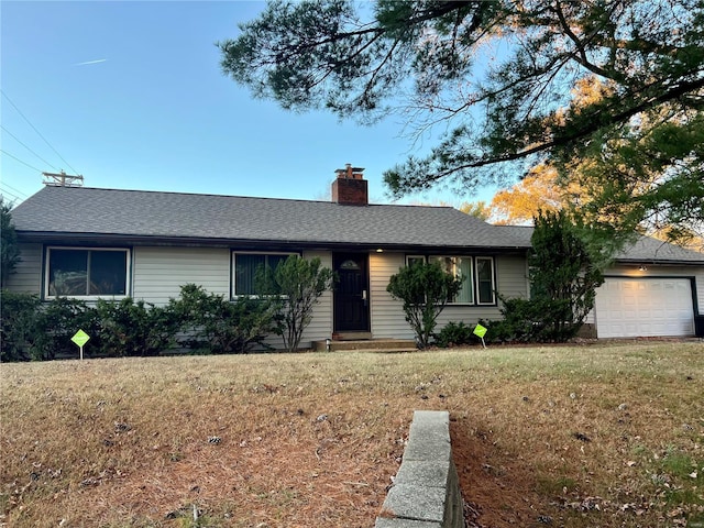 ranch-style home with a front lawn and a garage