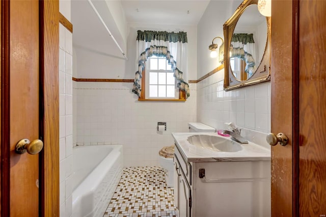 bathroom with a tub to relax in, vanity, tile walls, and toilet