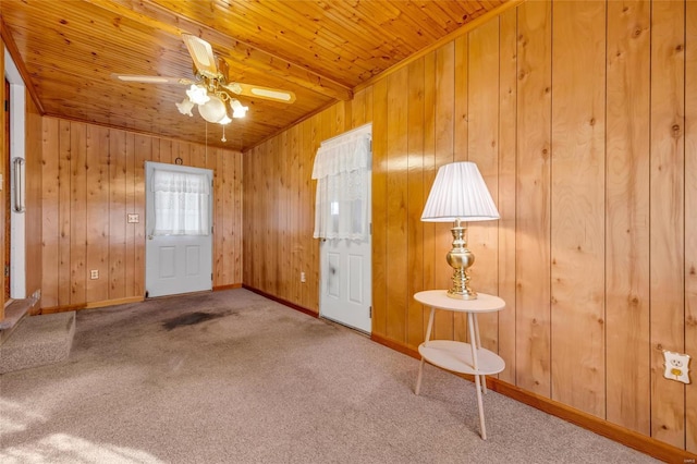 interior space with carpet floors and wooden walls