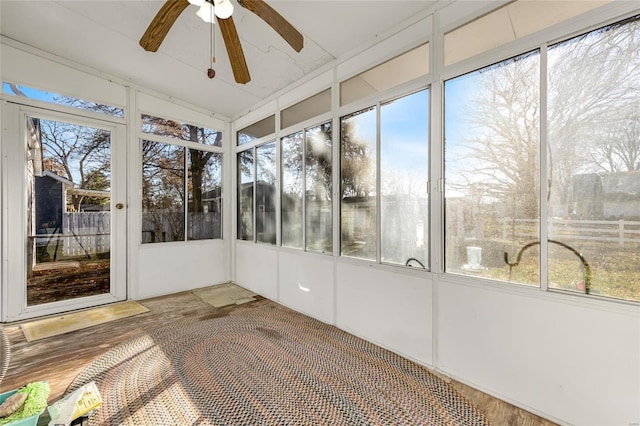 unfurnished sunroom with ceiling fan and a wealth of natural light