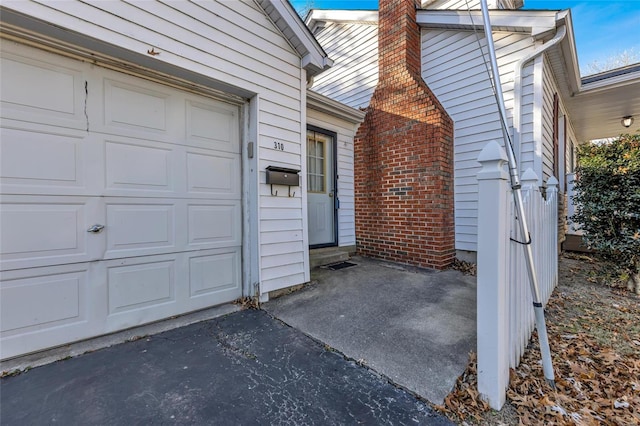 view of exterior entry with a garage