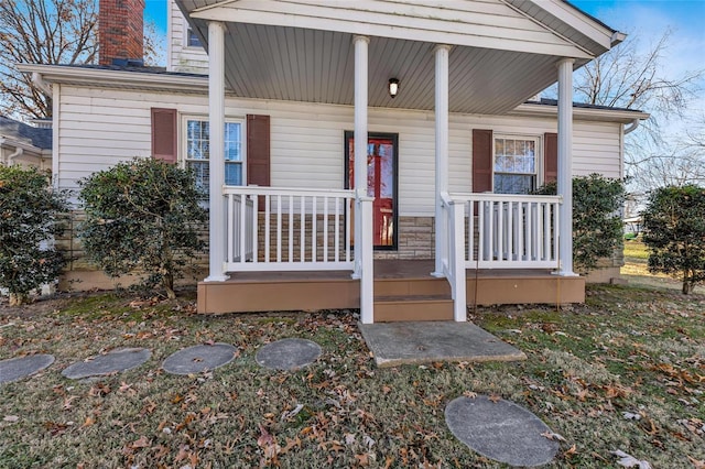 view of exterior entry featuring a porch