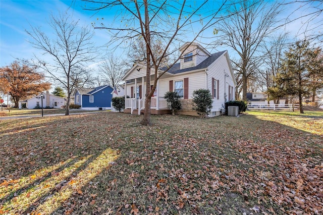 view of property exterior featuring a lawn and central AC