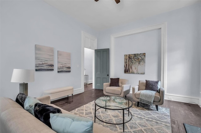 living room with dark hardwood / wood-style flooring and ceiling fan