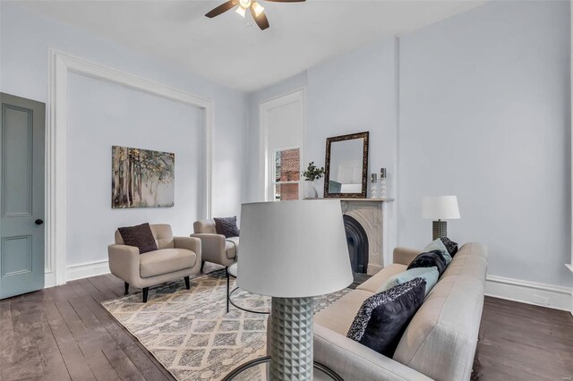 living room featuring ceiling fan and dark hardwood / wood-style flooring