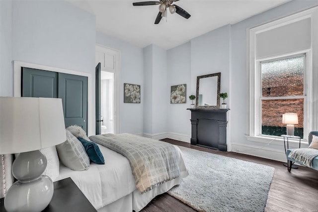 bedroom featuring hardwood / wood-style flooring, ceiling fan, and ensuite bathroom