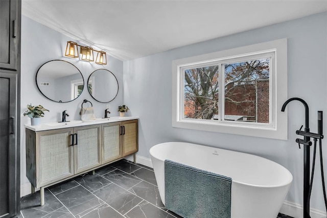 bathroom with a tub and vanity