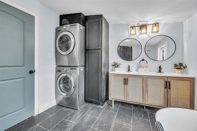 washroom featuring stacked washer and dryer and sink