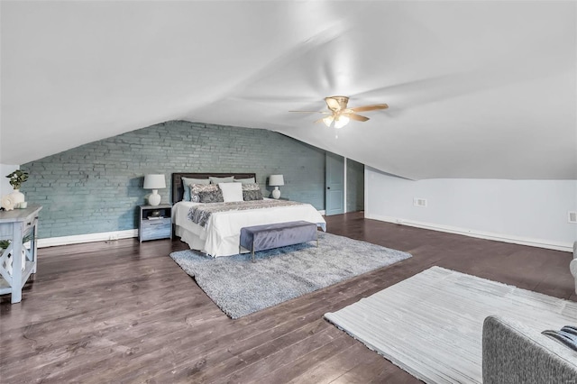 bedroom with dark hardwood / wood-style floors, ceiling fan, lofted ceiling, and brick wall